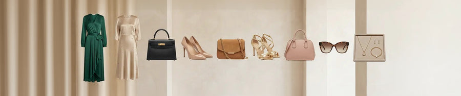 A curated fashion display showing multiple apparel and accessory items arranged against a warm beige interior wall: a dark green dress, a cream dress, a black handbag, nude high heels, a tan handbag, gold high-heel sandals, a pink handbag, tortoiseshell sunglasses, a necklace, and earrings.